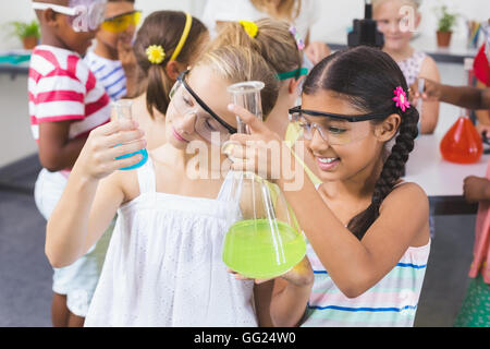 Kids doing a chemical experiment in laboratory Stock Photo