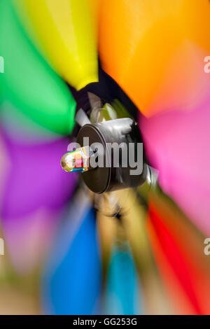 Colorful pinwheel spinning rapidly in the garden. Verical image. Stock Photo