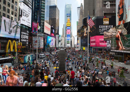 People walk through Times Square in Manhattan. Stock Photo