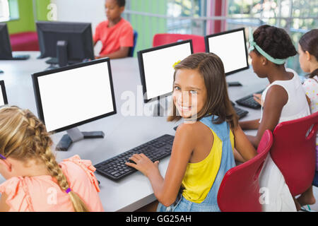 School kids using computer in classroom Stock Photo