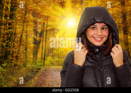 Portrait of a young happy woman hiking in a autumn forest Stock Photo