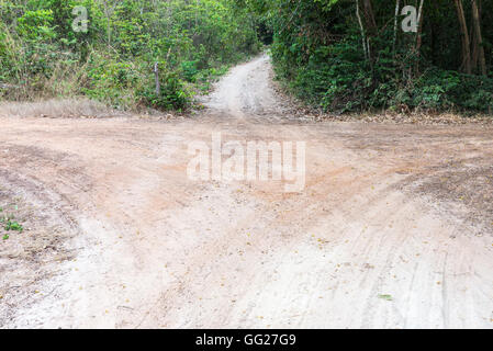 The junction of gravel road on the way to the paddy field in countryside of Thailand. Stock Photo