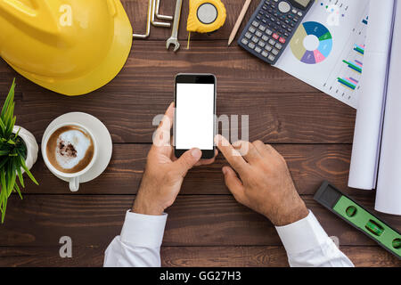 engineering using phone on his workspace top view Stock Photo