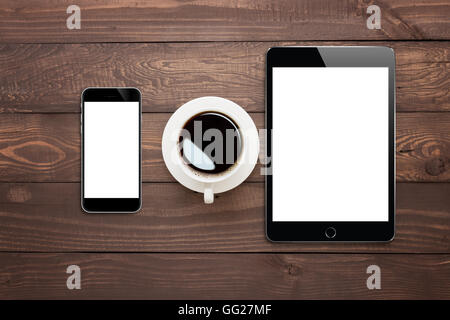 phone tablet and coffee cup on wood table top view Stock Photo