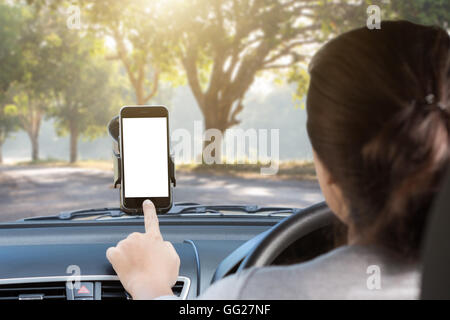 woman use phone mount to glass in car on rural road Stock Photo