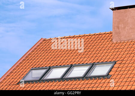 Smoke stacks on the tiled roof Stock Photo