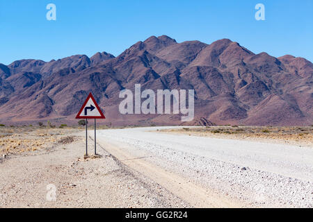 Namibia Right turn on a road in front of mountains. Stock Photo