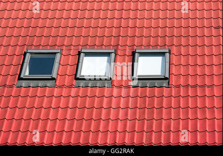 New orange tiled roof with three garret windows Stock Photo