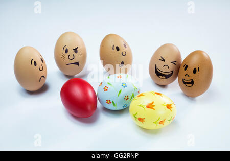 Egg faces are around some easter eggs. Stock Photo