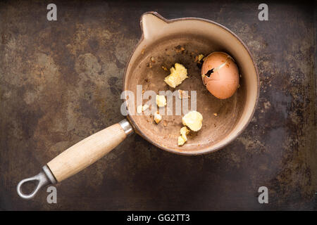an exploded egg in a saucepan that has been left to boil dry Stock Photo