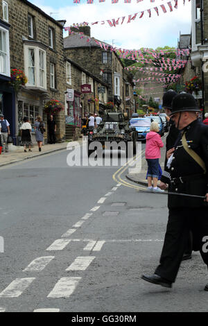 Armoured car and policemen as part of the 1940s weekend in High Street, Pateley Bridge, North Yorkshire, England, United Kingdom