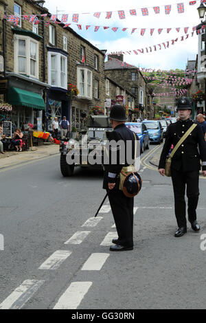 Armoured car and policemen as part of the 1940s weekend in High Street, Pateley Bridge, North Yorkshire, England, United Kingdom