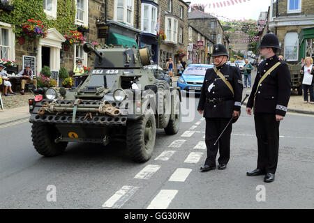 Armoured car and policemen as part of the 1940s weekend in High Street, Pateley Bridge, North Yorkshire, England, United Kingdom