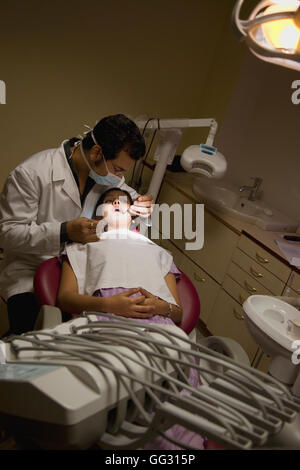 Dentist checking patient's teeth Stock Photo