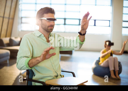 Male business executive using virtual reality video glasses Stock Photo