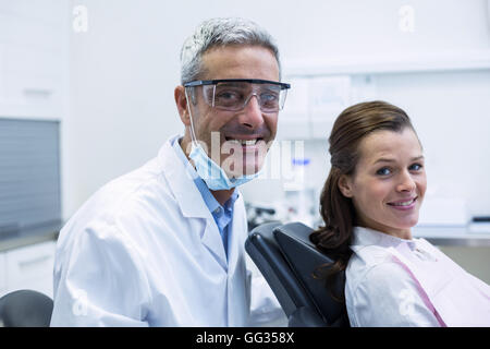 Portrait of smiling dentist and young patient Stock Photo
