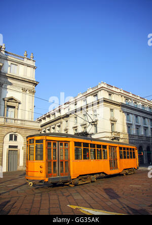 Old orange tram near La Scala theater in Milan, italy Stock Photo