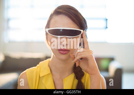 Female business executive using virtual reality video glasses Stock Photo