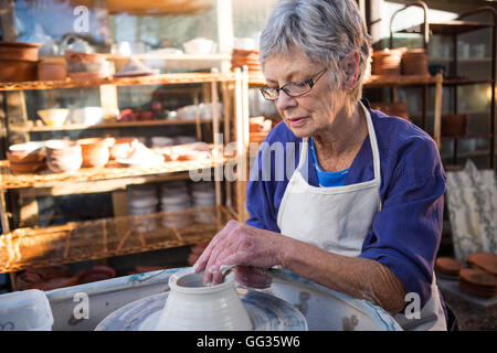 Female potter making pot Stock Photo