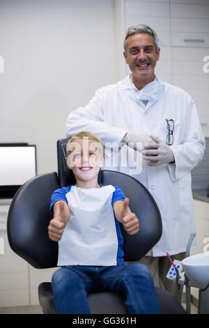 Portrait of smiling dentist and young patient Stock Photo