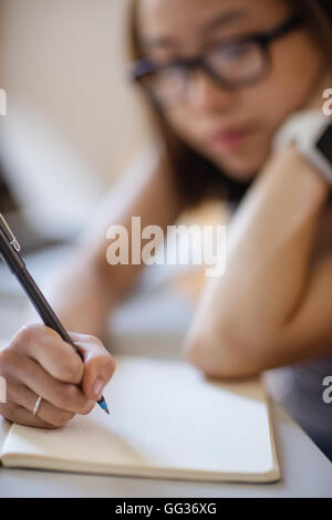 Young woman studying in classroom Stock Photo