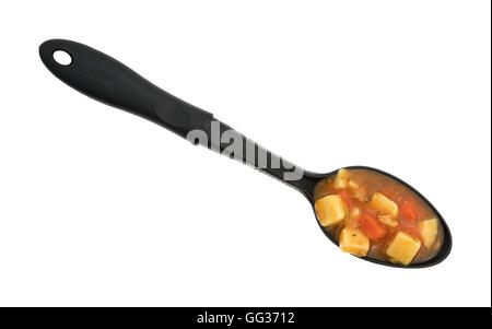 A portion of Manhattan style clam chowder on a large black kitchen spoon atop a white background. Stock Photo