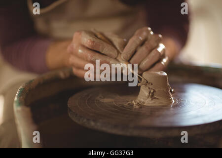 Close-up of potter working on bowl Stock Photo