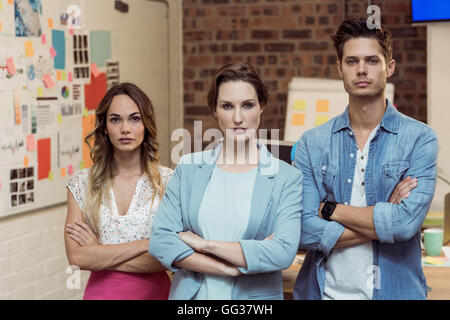 Business executives standing with arms crossed Stock Photo