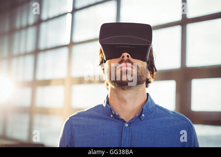 Male business executive using virtual reality headset Stock Photo