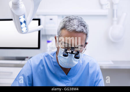 Dentist with surgical loupes Stock Photo