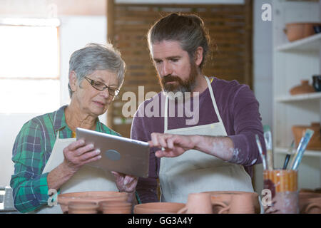 Potters using digital tablet Stock Photo