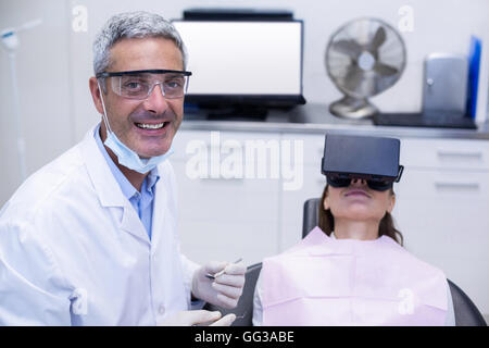 Female patient virtual reality headset during a dental visit Stock Photo