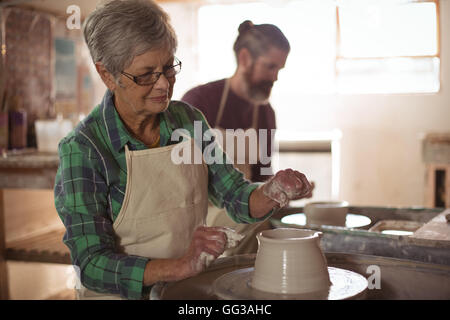 Female potter making a pot Stock Photo