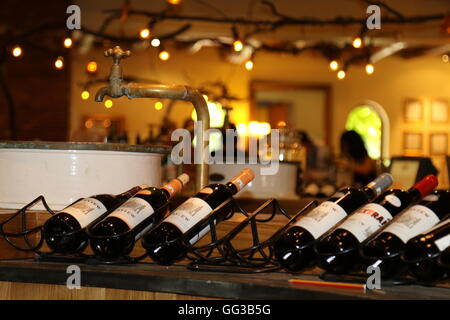 Bottles on  a rack on display at a wine tasting cellar door at Fairview Wines in Paar region in South Africa Stock Photo