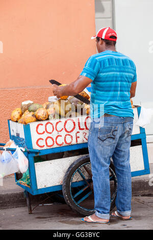 A street vendor selling coconut water in Dili East Timor in front of a ...