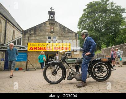 A man on a vintage motorcycle outside the venue of the annual show organised by the Egton Bridge Old Gooseberry Society in Egton Bridge, Yorkshire. Stock Photo