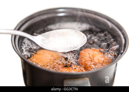 Closeup of three eggs boiling in pot  hot water Stock Photo