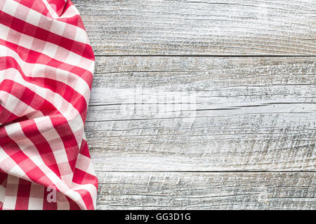 The checkered napkin on old kitchen table. Stock Photo