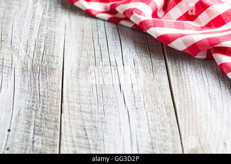 The checkered napkin on old kitchen table. Stock Photo
