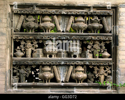 A brick-carving window in the wall at the Lion Garden of the Chang Mansion in Yuci, Shanxi – China. Stock Photo