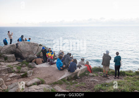 Cape Finisterre, Spain: Pilgrims gathered at  Cape Finisterre Lighthouse at sunset after completing the Way of St. James. Stock Photo