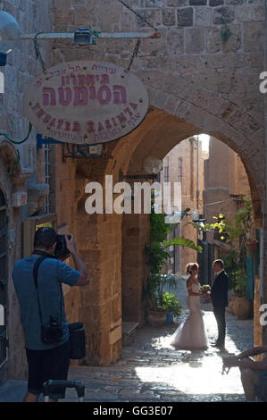 Jaffa, Israel: a newlywed couple with the photographer in the alleys of the Old City, chosen as perfect location for weddings Stock Photo