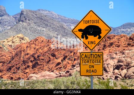 Road sign reading 'Tortoise Crossing' in desert setting. Stock Photo