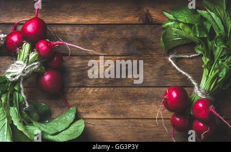 Fresh radish bunches over rustic wooden background, copy space Stock Photo