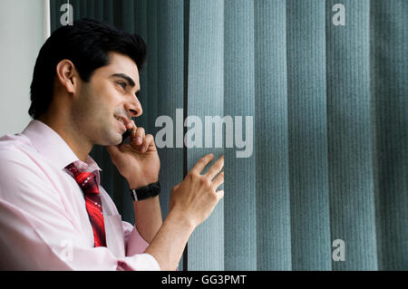 Executive talking on his cell phone Stock Photo
