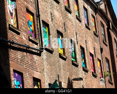 Building in Button Street with paintings in each window Liverpool Lancashire Stock Photo