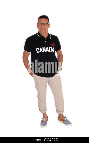 A handsome Hispanic man standing in a shirt with Canada on standing isolated for white background. Stock Photo