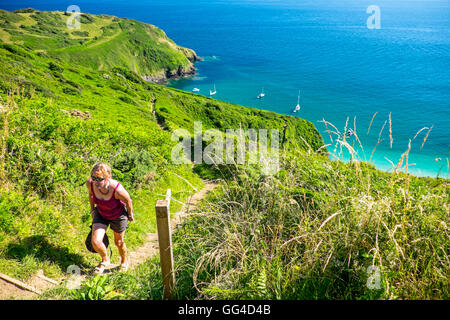 Female walker on the South West Coast Path above Lantic Bay near Polruan,Cornwall Stock Photo