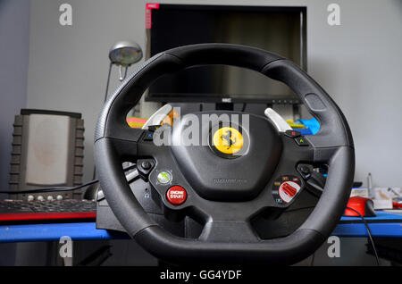 computer gaming rig - includes steering wheel assembled to desktop. monitor and speakers. Stock Photo
