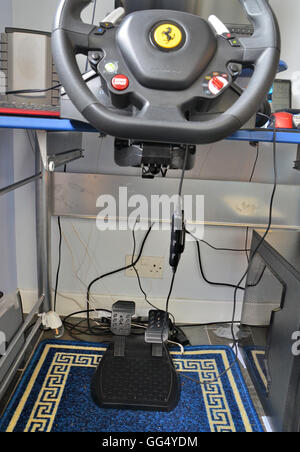 computer gaming rig - includes steering wheel assembled to desktop and  foot pedals, brake and accelerator and speakers. Stock Photo